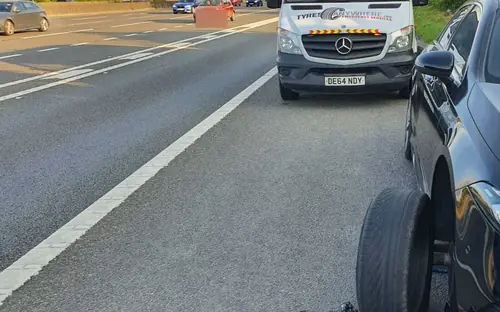Our van behind a car on a motorway hard shoulder during a tyre change