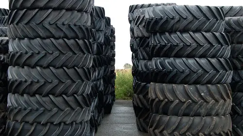 Two tall stacks of new tyres