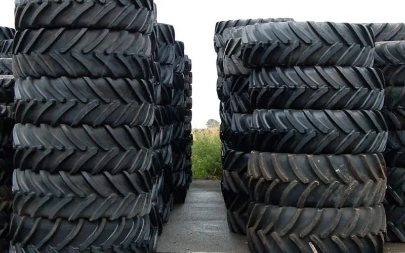 Two tall stacks of new tyres