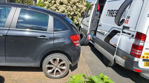 A Tyres Anywhere van beside a car having its tyres replaced on a driveway