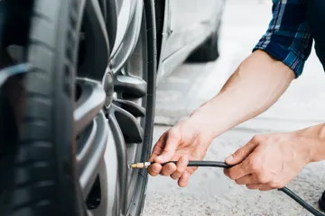 Man pumping a tyre with air