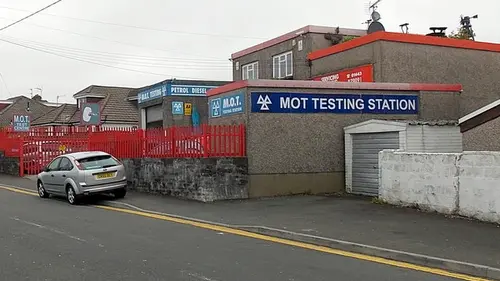 A garage with an MOT testing station sign